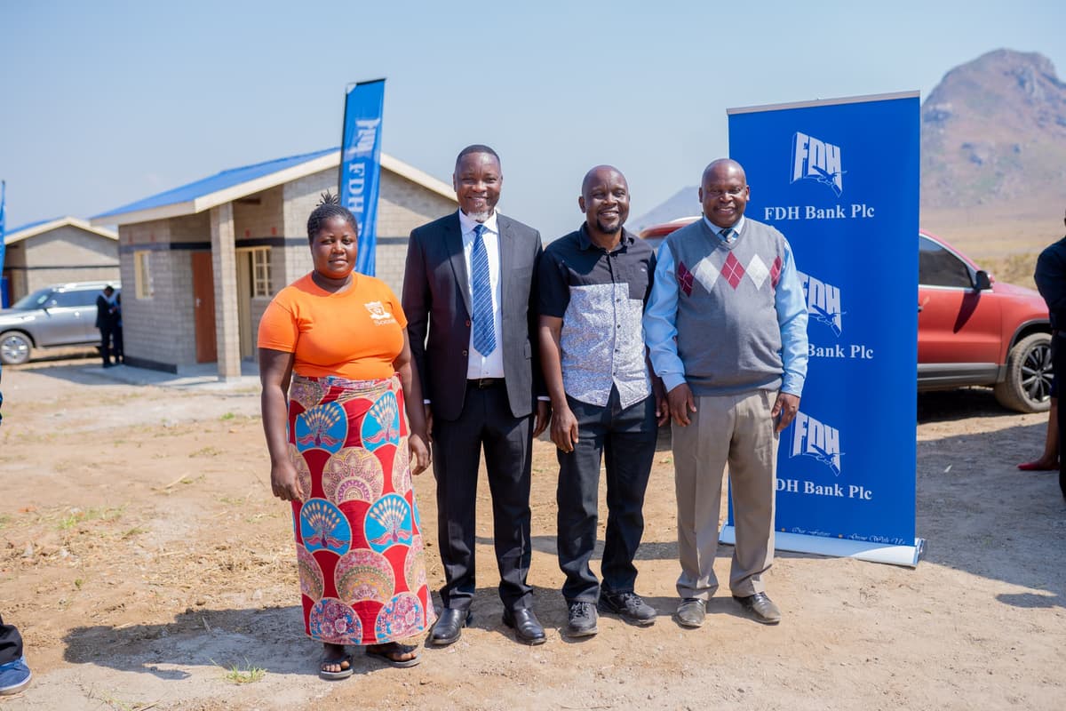 FDH Bank Managing Director Noel Nkulichi (2nd from left) and others posing on newly constructed houses